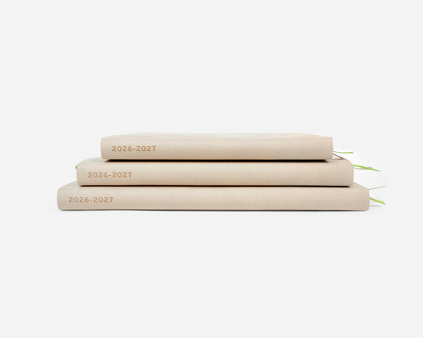 Three beige planners stacked on a white background with '2026-2027' on the spines.