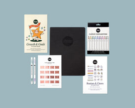 Collection of stationery items including a sticker book, a weekly planner, and highlighters on a blue background.