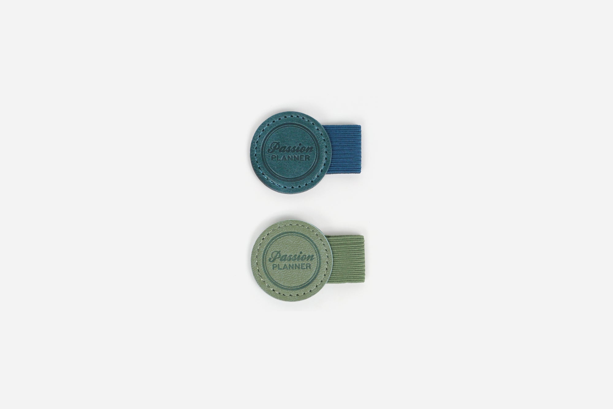 Two pen loops, one teal and one green, on a white backround